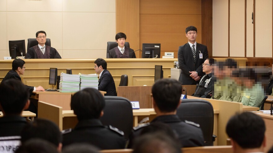 Sewol ferry crew members, whose identities are obscured in this photo at the request of the court, attend verdict proceedings in Gwangju, South Korea, Tuesday. Ferry captain Lee Joon-Seok was sentenced to 36 years in jail.