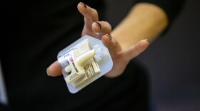 Amy Delaney, program manager at Boston Public Health, holds a single dose of Narcan nasal spray at the Overdose Prevention & Naloxone Training Program at Boston Medical Health Clinic. (Jesse Costa/WBUR)