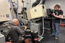 Milwaukee Film technical director Kevin Rice (right) and renowned Chicago-based projectionist James Bond work on installing brand new shutters for the projector that were manufactured specifically for the Oriental Theater's projectors.