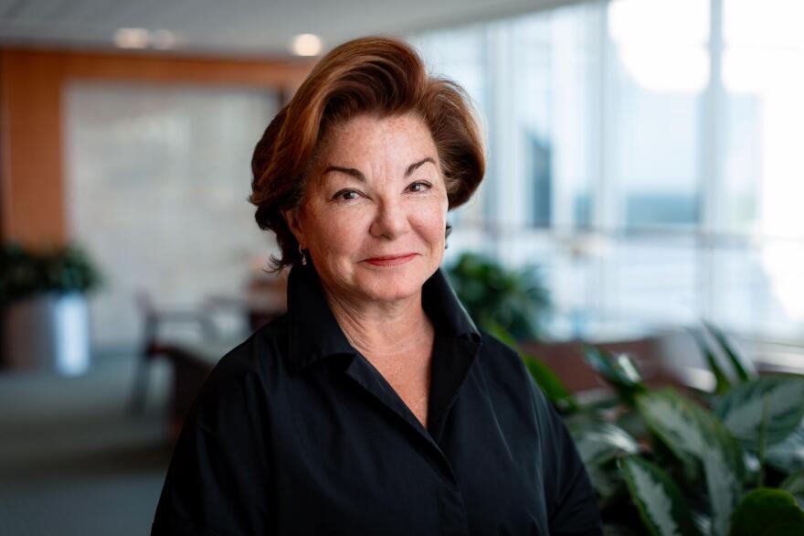 Woman with red Hair and black blouse poses for professional picture