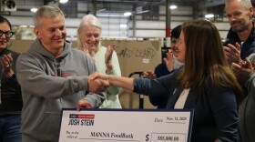Gov. Josh Stein presenting a check to Claire Neal, CEO of MANNA Food Bank, on Nov. 13