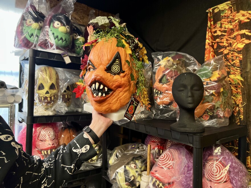 David Lady holds up "Jackie Lantern," the latest of his limited-time mask creations.