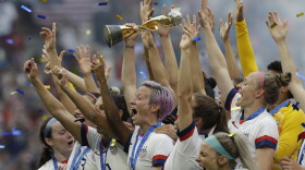 United States' Megan Rapinoe holds the trophy after winning the Women's World Cup final soccer match between US and The Netherlands at the Stade de Lyon in Decines, outside Lyon, France, Sunday, July 7, 2019.