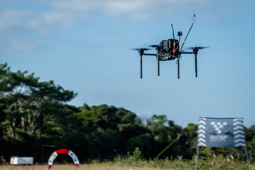 A Neros Archer drone flies during the Marine Corps Attack Drone Competition in Okinawa, Japan, Dec. 7, 2025. The Archer is one of the models that the Pentagon is purchasing as it tries to amass a supply of more than 300,000 small attack drones.