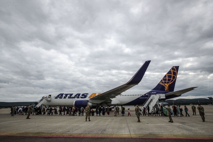 Afghan evacuees line up at the U.S. Air Base in Ramstein, Germany, on Aug. 26, 2021. After leaving Afghanistan, refugees travelled through the Middle East, before arriving at one of several U.S. bases in Europe.