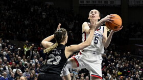 UConn Huskies guard Paige Bueckers #5 is fouled going to the basket by UCF Knights guard Alisha Lewis #23 as the UConn Huskies take on UCF Knights during the NCAA Tournament second Round at Gampel Pavilion in Storrs, Connecticut March 21, 2022.