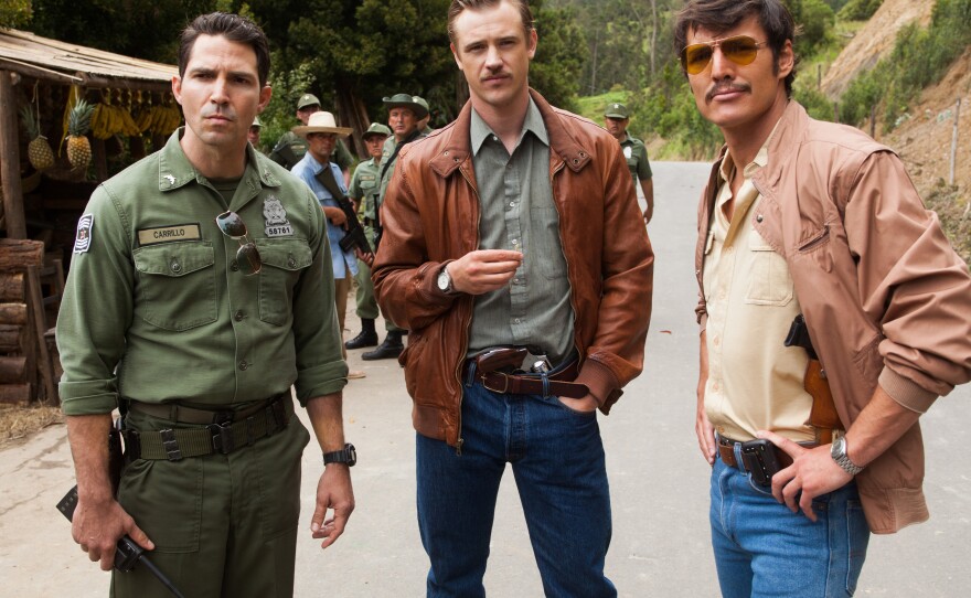 <em>Narcos</em> tells the story of the hunt for Pablo Escobar — a hunt in which DEA agents Steve Murphy (Boyd Holbrook, center) and Javier Peña (Pedro Pascal, right) worked closely with Colombian police. (Also pictured: Maurice Compte).