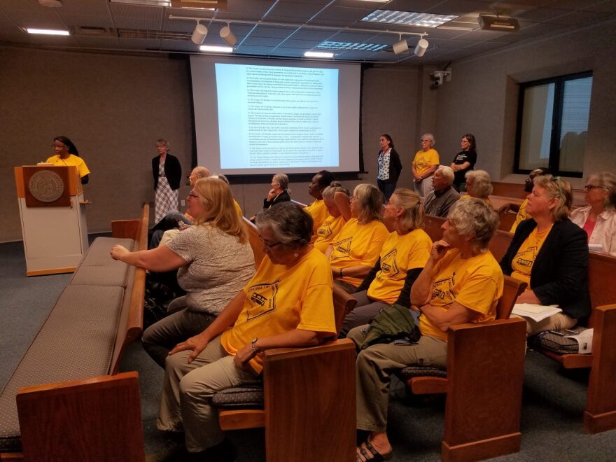 Alachua County Racial Justice Task Force members donned their group's yellow t-shirts at Tuesday’s county commission meeting, where they voiced opinions on the county’s truth and reconciliation efforts. (Rebecca Santana/WUFT News)