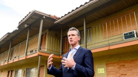 California Governor Gavin Newsom speaks with reporters while touring an inn being converted to interim housing for the homeless, on Jan. 13, 2022, in Santa Clara, Calif.