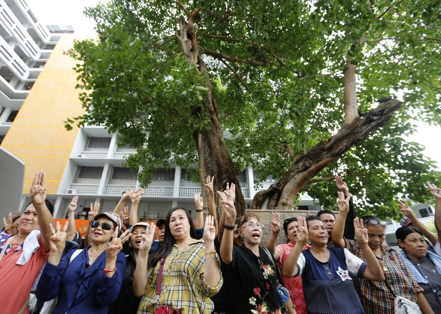 Thai protesters demonstrate during an anti-coup rally at Thammasat University in Bangkok on Sunday. At least two protesters were arrested as thousands of soldiers and police were deployed in Bangkok to thwart sporadic protests against the May 22 coup.