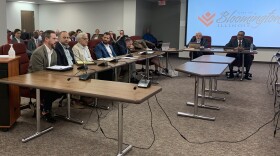 Patrick Hoban, head of the Bloomington-Normal Economic Development Council, left, speaks at the Bloomington City Council meeting Monday, Aug. 22, 2022, at the downtown Government Center.