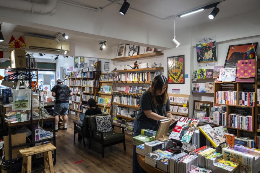 Leticia Wong, former pro-democracy district councillor, arranges books at her bookstore in Hong Kong, Friday, June 20, 2025. (Chan Long Hei/AP)