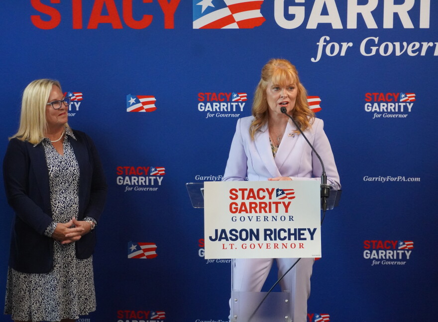 Stacy Garrity (right, at podium) spoke Aug. 27, 2026 at Family Pizza & Pub, a small restaurant in Altoona. Several other Republican state lawmakers spoke at the event as well, including Sen. Judy Ward (left).