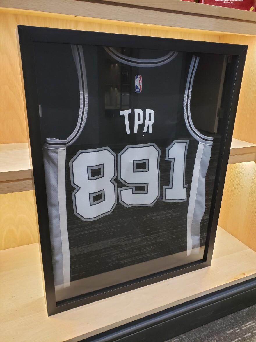 "Wembymania" is sweeping through San Antonio eve of official selection by team, including Texas Public Radio with this Spurs jersey emblazoned with its frequency.