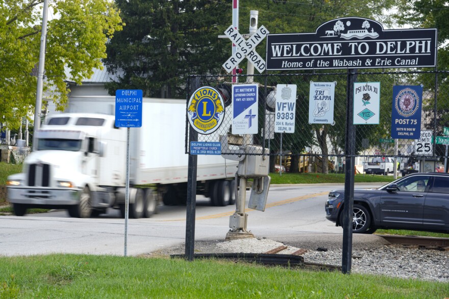 A semi-truck crosses a railroad crossing on the edge of town in Delphi, Ind., Tuesday, Oct. 1, 2024.