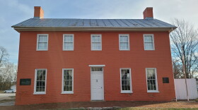 red brick Federalist-style, two-story home