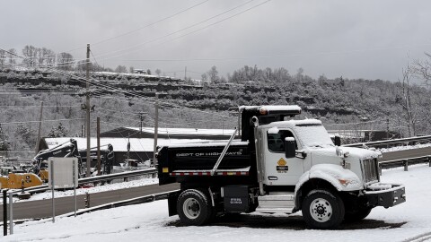 A Kentucky Transportation Cabinet truck sits under a light layer of snow at the KYTC Division of Equipment Facility in Frankfort, where Governor Andy Beshear, Transportation Secretary Jim Gray, and Kentucky State Police Trooper Brian Washer held a press conference Tuesday morning.