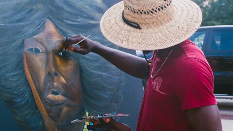 Local artist paints a portrait at 2025 Black Culture Festival at Parcel 5