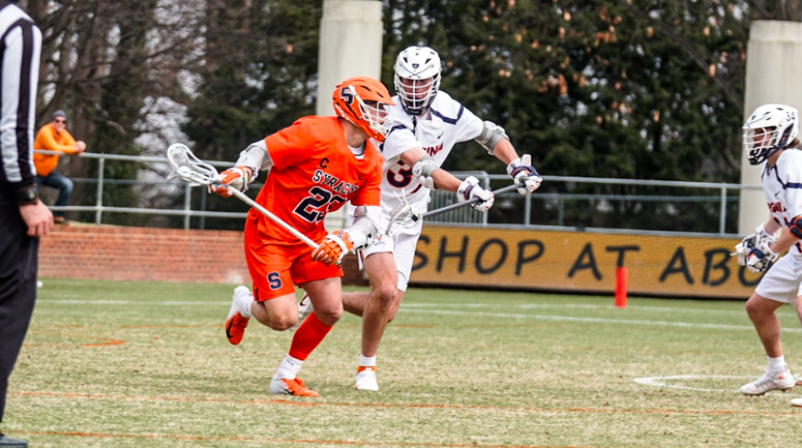 Cole Kastner (39, white) closely marks Tucker Dordevic (23, orange) in UVA's 20-11 win earlier this year