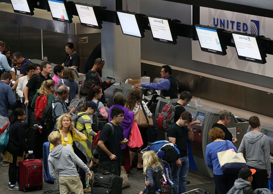 United passengers wait to check in at San Francisco International Airport on July 8. A similar computer problem disrupted flights in June as well.