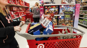 FILE- In this Nov. 23, 2018, file photo shoppers browse the aisles during a Black Friday sale at a Target store in Newport, Ky. Comparable stores sales at Target fell well below the previous year, joining a growing list of retailers reporting a meager performances during the critical holiday shopping season. Target said Wednesday, Jan. 15, 2020, that it had weaker-than-expected sales of electronics, toys and some home good. Those sales climbed 1.4% in the November-December period, compared with a 5.7% increase a year earlier. (AP Photo/John Minchillo, File)