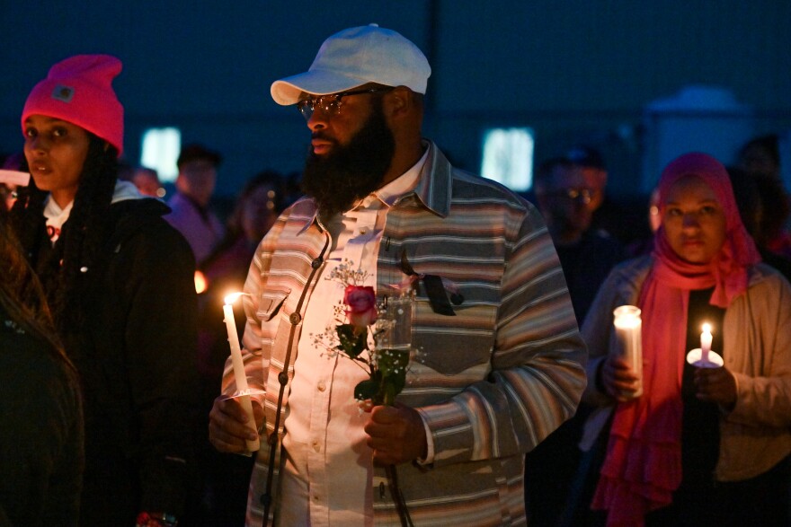 Antoine Clark holds a candle and a pink rose at a vigil Saturday, Feb. 28, 2026 in Wilkes-Barre for his 15 year-old daughter La'Nyiah 'Lala' Clark, whose remains were found nearby on Feb. 21.