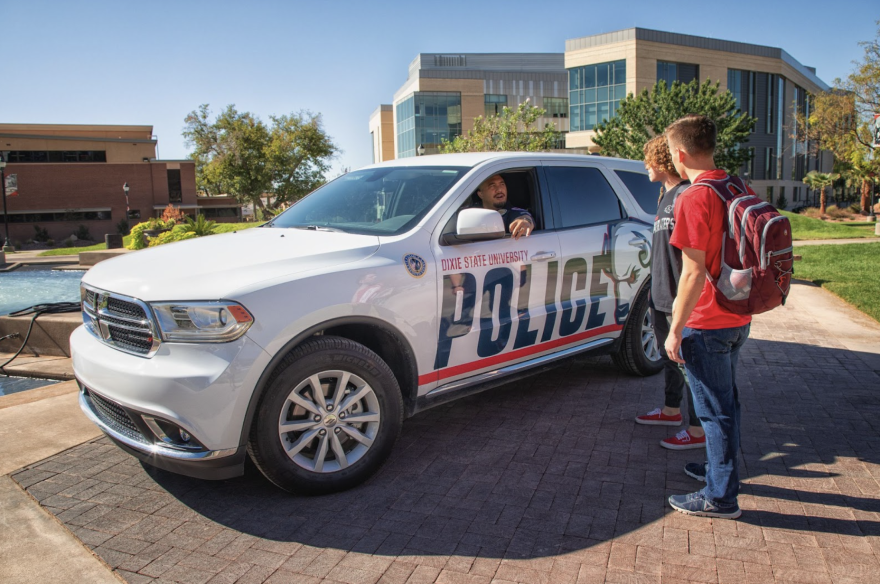 A Dixie State University police officer talks with students as part of his routine patrol. DSU Police is the only agency in Utah to have gained Active Bystandership for Law Enforcement certification.