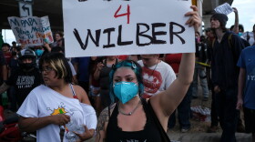 People speak during a demonstration where a man was shot in his vehicle by an ICE officer, Sunday, Sept. 20, 2026, in Austin, Texas. (AP Photo/Joel Angel Juarez)