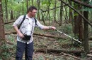 Ben Jellen, an associate professor of biology at St. Louis College of Pharmacy, using a radio receiver to track a copperhead snake at Powder Valley Nature Center on August 30, 2019.