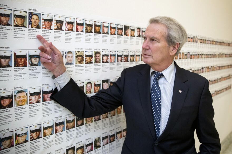  U.S. Rep. Walter Jones, R-N.C., points at a photograph of Marine Sgt. Michael Edward Bits of Ventura, Calif., the first military funeral he and his wife attended, 