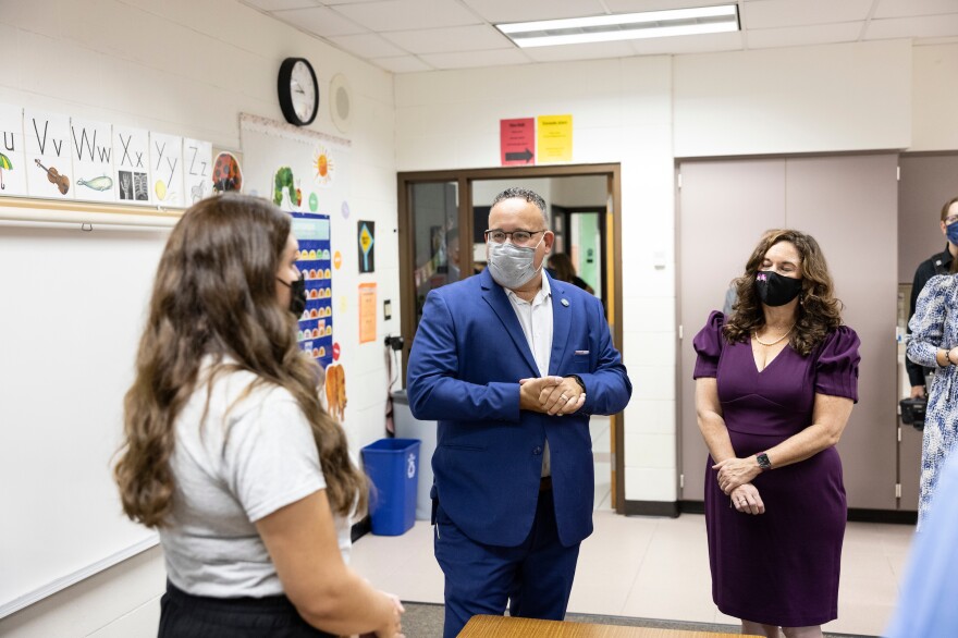 Cardona, center, and U.S Deputy Secretary of Education Cindy Marten, right, talk with staff at Locust Lane Elementary.