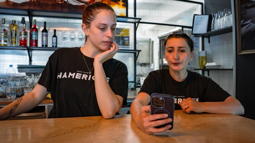 Elisa Serracini (from left) and Eljona Bushpepa stand behind the counter at Hamerica Restaurant in Rome Wednesday.