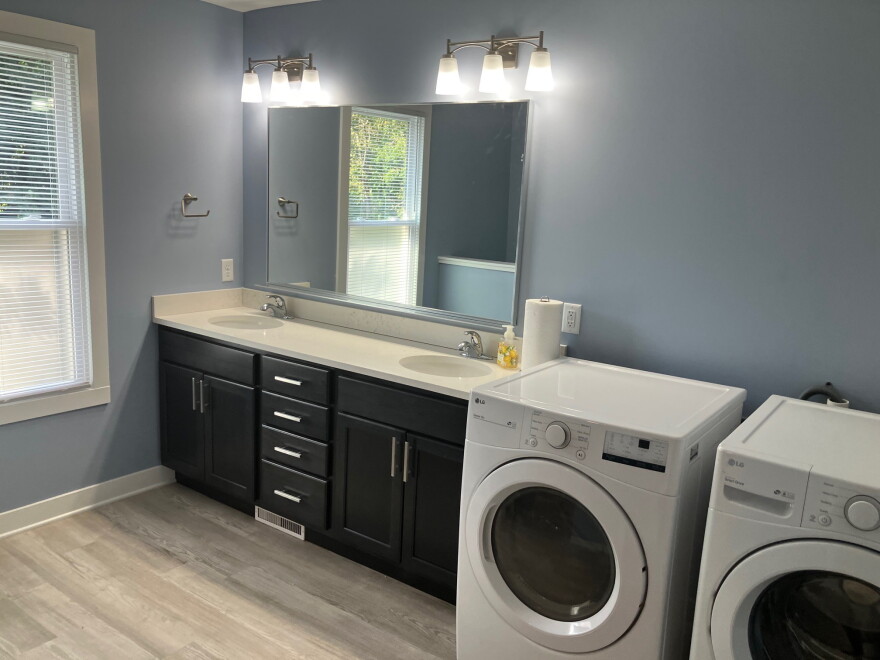 A second-floor full bathroom includes a washer and dryer. The home is on the market for $170,000.