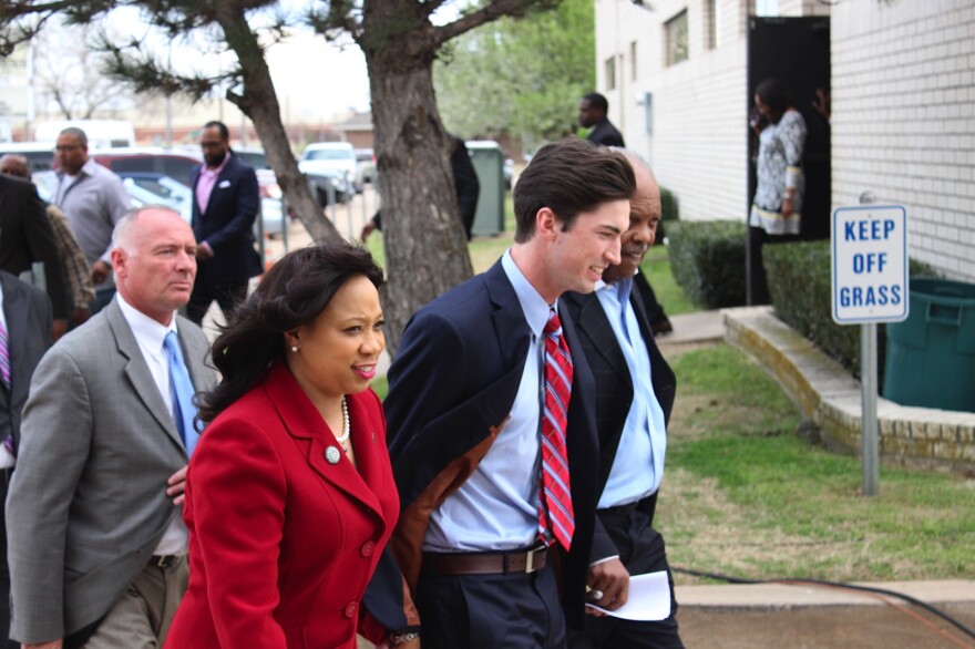 Levi Pettit, center, walks into the Fairview Missionary Baptist Church in Oklahoma City with state senator Anastasia Pittman and pastor J.A. Reed, Jr.