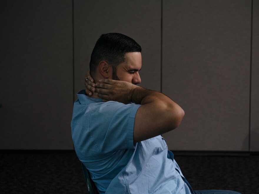 Salva experiences pain while sitting at the Central Rappahannock Regional Library in Stafford, Va. His boss purchased some ergonomic furniture and allows Salva to work flexible hours.