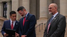 Sen. Shane Jett, R-Shawnee, talks to Sen. Dusty Deevers, R-Elgin, during the announcement of the newly established Oklahoma Freedom Caucus outside the Oklahoma State Capitol, Sept. 3, 2024. To their left, Sen. Dana Prieto, R-Tulsa, stands attentively as Deevers is announced up next to speak. Jett chairs the new freedom caucus and Deevers vice chairs.