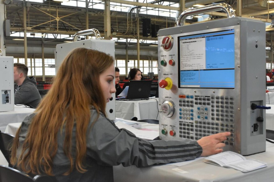 A career and technical education student in Indiana programs a machine at a statewide SkillsUSA competition.