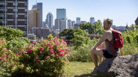 Miles Howard stops to enjoy the view of Boston from Kevin W. Fitzgerald Park. (Robin Lubbock/WBUR)
