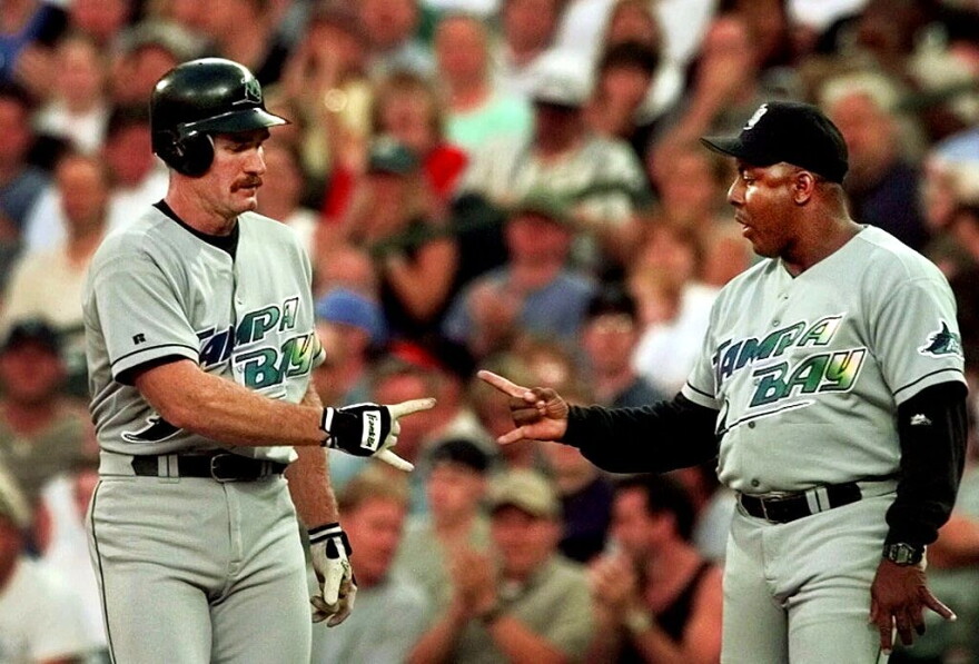 Tampa Bay Devil Rays' Wade Boggs, left, gets congratulations from first base coach Billy Hatcher after Boggs sluggged a second-inning single against the Seattle Mariners Wednesday, Aug. 4, 1999 in Seattle. The hit was the 2,997th of his career.