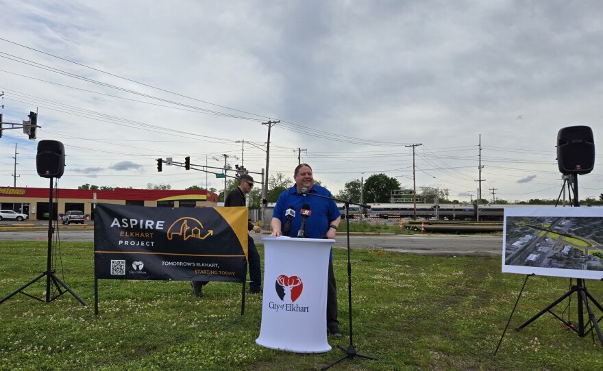 Elkhart Director of Public Works Jeffrey Schaffer discusses the Hively Avenue overpass project as Amtrak's Lake Shore Limited passes in the background.