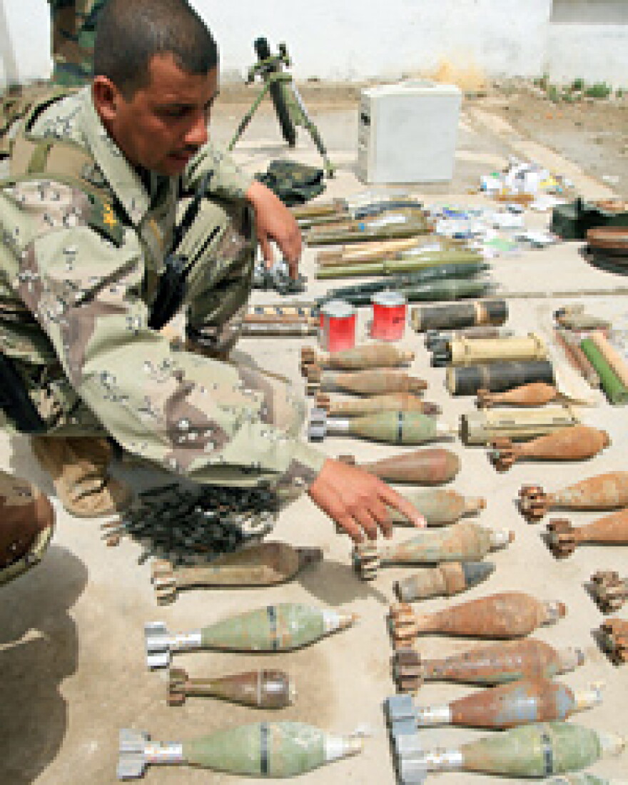 Iraqi army soldiers inspect a cache of weapons found during a raid in the southern Iraqi city of Basra on April 10, 2008. Many of the weapons found during the raid were manufactured in Iran, an Iraqi Army Colonel told AFP.