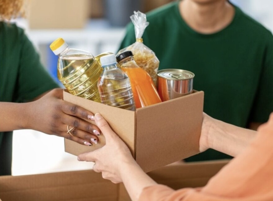 People handing boxes of food to each other
