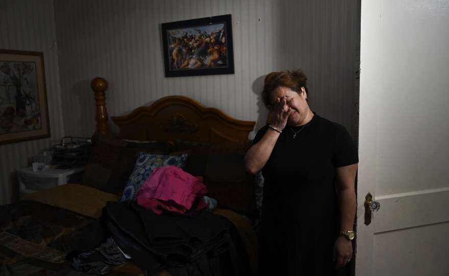 On a day filled with unexpected memories, Glenda Cardenas is brought to tears while putting the clothes she found in the attic in the bedroom she shared with her husband, the late Miguel Torres. She keeps the door to this room closed and will not sleep there. At 24, she crossed the U.S. border undocumented and met and married Torres, a U.S. citizen from Puerto Rico. In 2018, Cardenas was deported to Honduras and was separated from her family, who remained in Waterbury. Cardenas was allowed back temporarily this year after her husband became gravely ill.