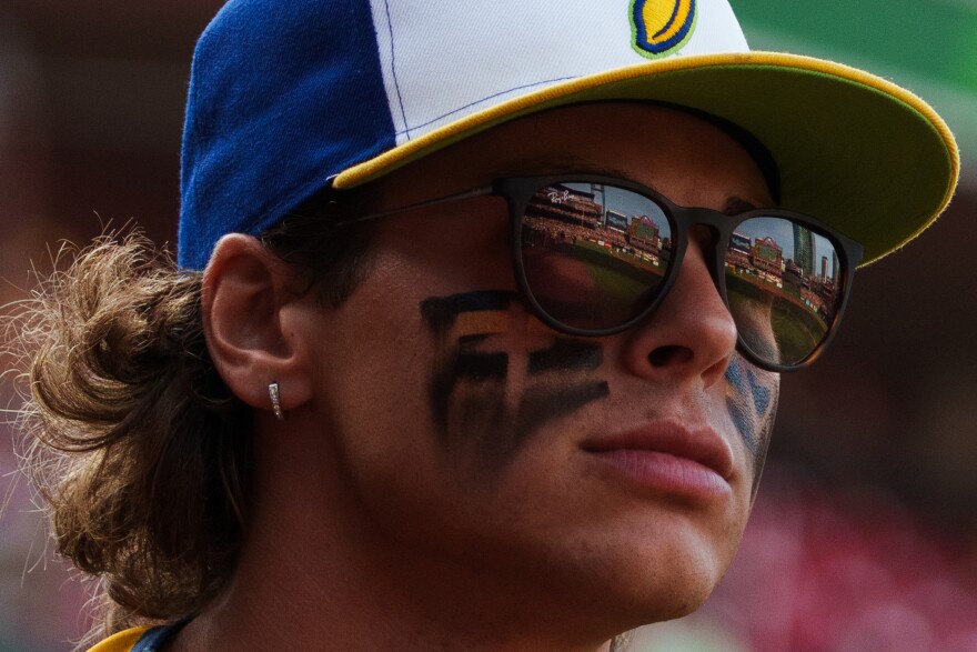 Savannah Banana KJ Jackson walks on to the field while Busch Stadium reflects off his glasses before the baseball game between the Savannah Bananas and the Party Animals at Busch Stadium on Friday, July 18, 2025, in downtown St. Louis.