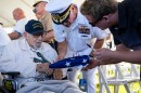 FILE - An attendee asks Pearl Harbor survivor Ira "Ike" Schab, 103, to sign an U.S. flag during the 82nd Pearl Harbor Remembrance Day ceremony on Thursday, Dec. 7, 2023, at Pearl Harbor in Honolulu, Hawaiʻi.
