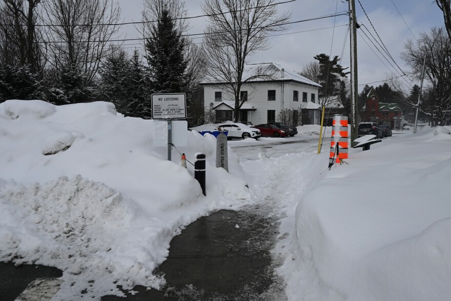 A sidewalk spans the border between Derby Line, Vermont, and Stanstead, Quebec, next to the Haskell Free Library on Friday, Feb. 28, 2025. Patrons in Stanstead could use this sidewalk to access the main doors to the library, which are located on the other side of the border, in Derby Line.