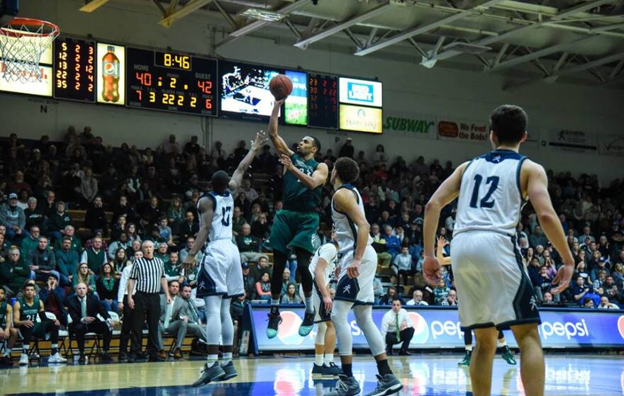 Action shot of Chris Ndow vs WU basketball