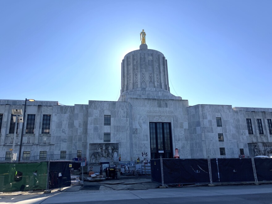 The Oregon Capitol. Construction equipment and fencing is seen in the foreground. 