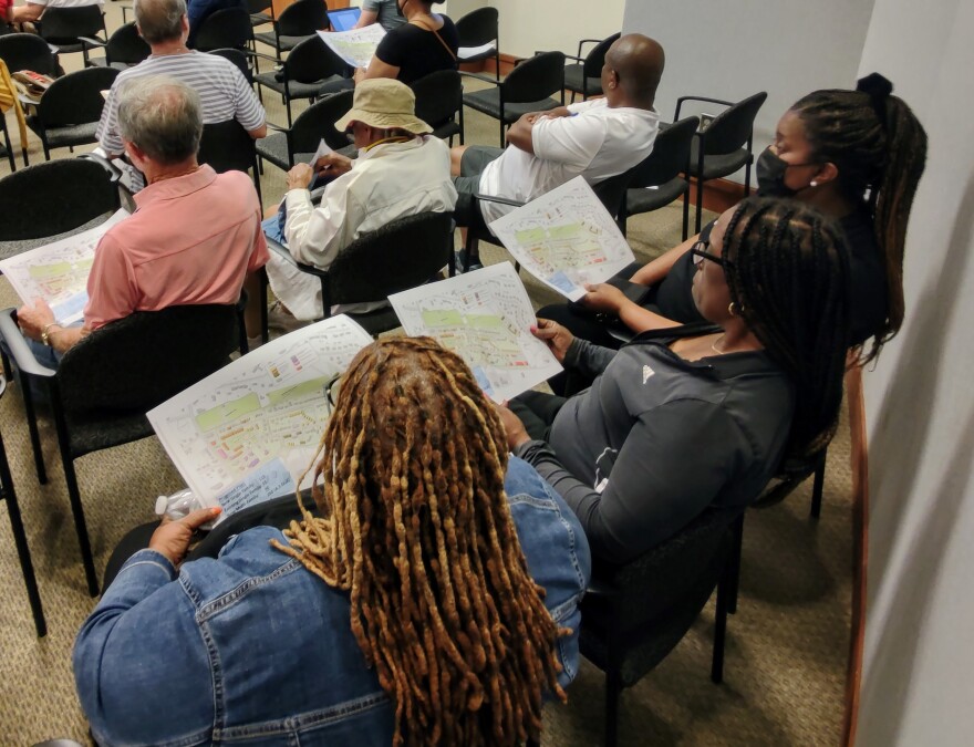 A group of people look over the schematics for the Smithville Revitalization Plan at June 7 informational meeting in Cornelius. The plan seeks to redevelop an aging historically Black neighborhood. The plans were developed by local Smithville residents. and the city of Cornelius will vote on the plans Monday.