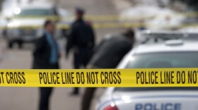 crime scene. Detectives and officer in background. 